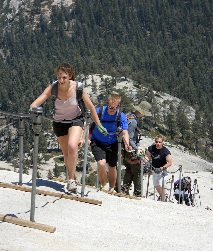 Climbers pull themselves up the steel cables on Half Dome’s steep east face. 