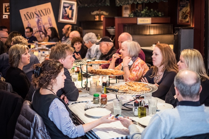 Tourists on the Chicago Pizza City USA tour pause for more pizza at Pat's Pizzeria.