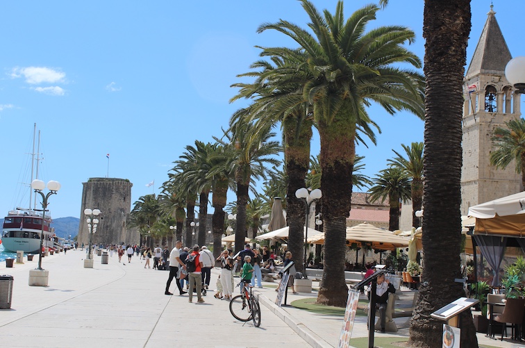 The palm tree-lined promenade along Trogir’s harbor allows visitors to stroll between the Kamerlengo Castle at the island’s edge and the 17th-century St. Lawrence Cathedral. 