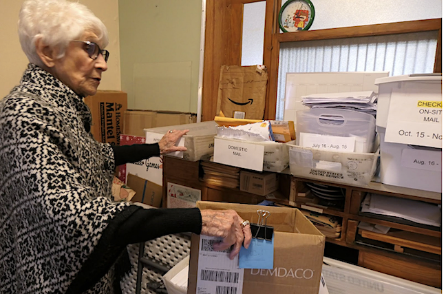 Pat Koch inside the small room where volunteer elves sort mail to Santa.