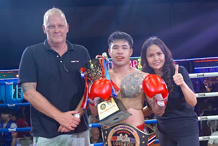 Forever Muay Thai's Per Albertsen, left, and TookTook Jantima flank Kru Chanom after a championship fight. 