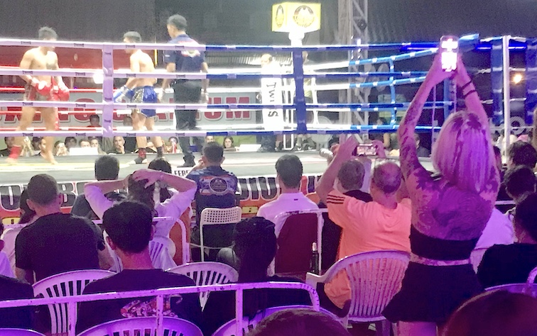 Bar girls join a mixed local and farang fan base in cheering a Muay Thai card at the Loi Kroh Boxing Stadium.