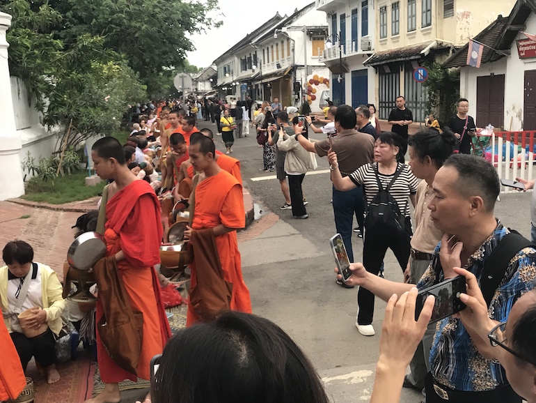 Carrying nothing but their saffron robes and alms bowls, monks complete a circuit of historic Luang Prabang each morning. Almsgivers believe their support will earn them merit in their next and future lives. Tour guides may recommend appropriate behavior, but they are frequently ignored by overzealous photographers.