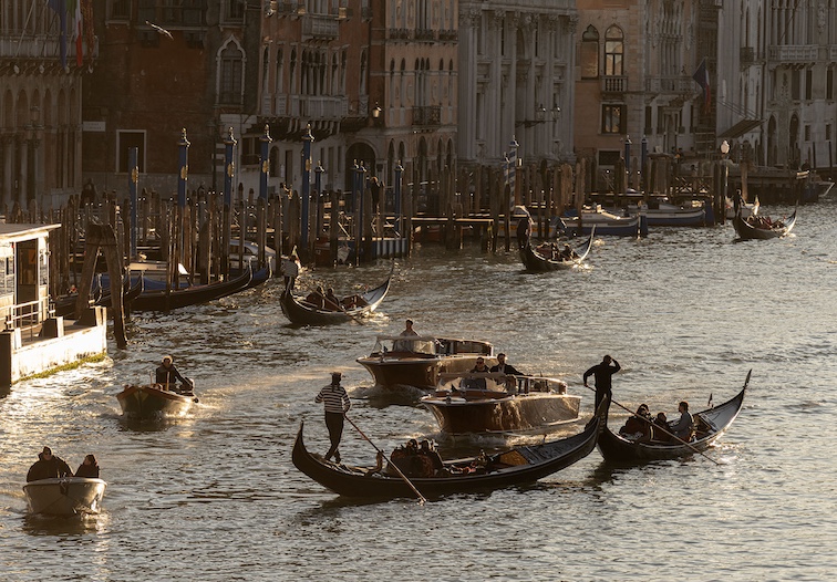 This view of gondolas, water taxis and private boats (their cars), plying the Grand Canal, was shot in late afternoon from the landmark Rialto Bridge.
