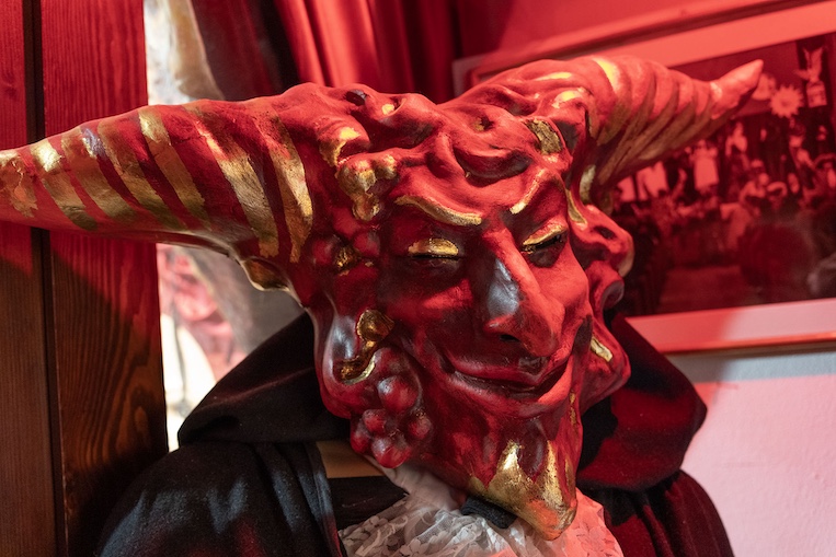 A smiling/leering Red Devil Satan guards the door at the fantastically rich mask workshop La Bottega dei Mascareri in the sestieri of San Polo