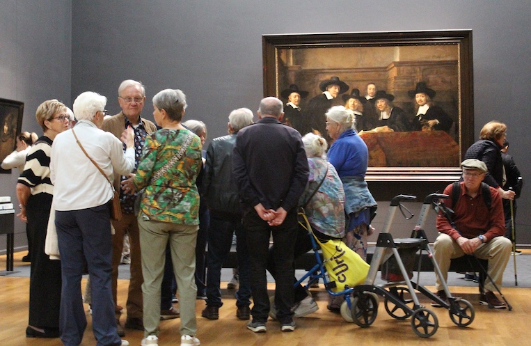 Visitors crowd along the Dutch masterpieces in Amsterdam’s Rijksmuseum.