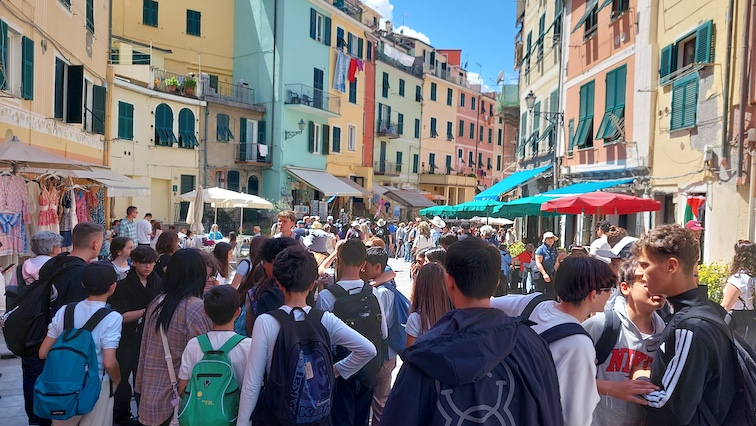 A tour group of students who have just arrived by train in central Vernazza, noted as the most popular and scenic town of Italy’s Cinque Terre (Five Lands).