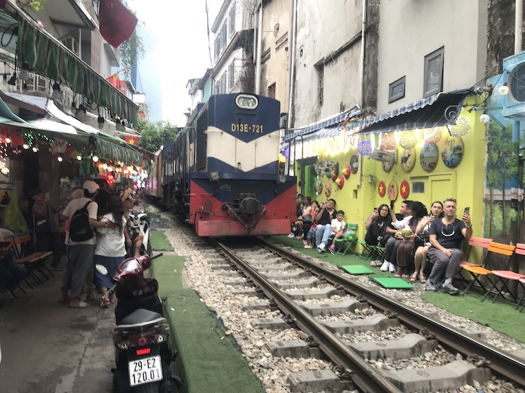 There are at least two different locations in Hanoi where, several times daily, commuter trains put the froth on cappuccino drinks at makeshift coffee shops. Both are called Train Street."